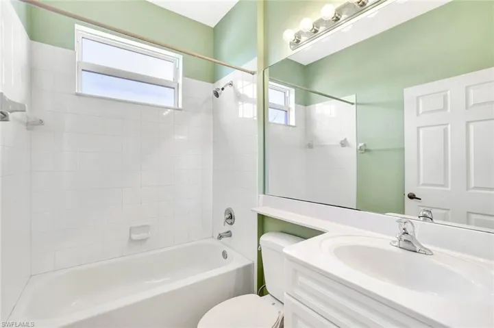 Full bathroom with toilet, vanity, and shower / bathtub combination