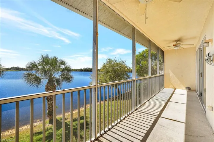 Balcony featuring a water view and ceiling fan