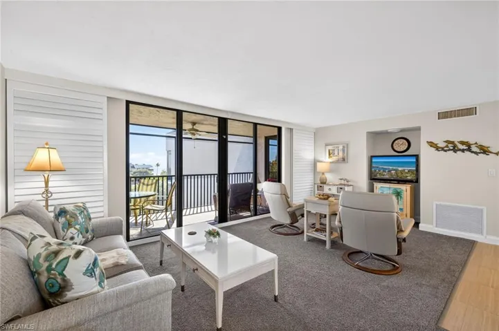 Living room with floor to ceiling windows and carpet