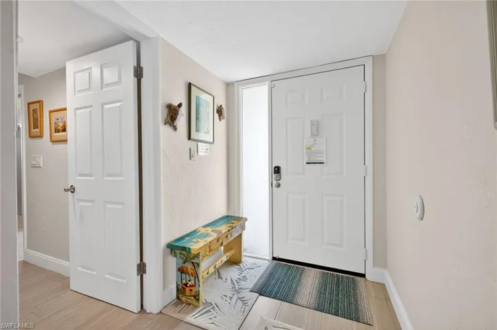 Entryway featuring light wood-type flooring and a textured wall