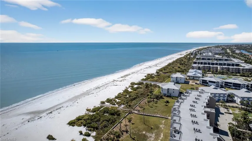 Drone / aerial view of a large body of water and apartment complex