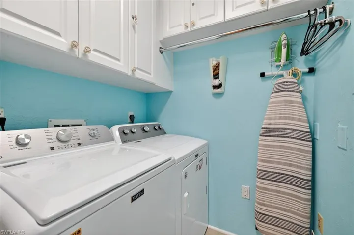 Laundry room with cabinet space and washing machine and dryer
