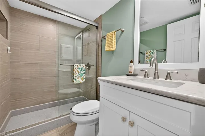 Full bathroom featuring vanity and a shower stall