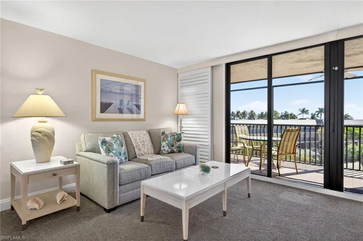 Carpeted living area with baseboards