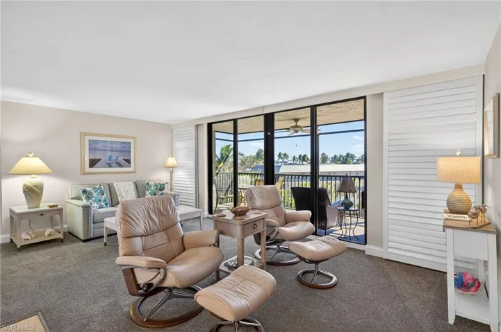 Living room featuring carpet flooring and baseboards