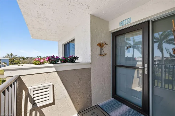 Doorway to property featuring stucco siding