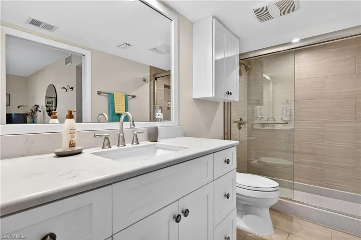 Full bathroom with vanity and a stall shower