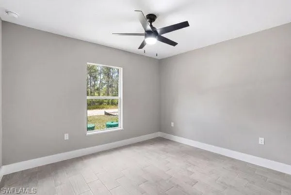 Room featuring a ceiling fan with integrated lighting, a single window, and light-toned tile flooring