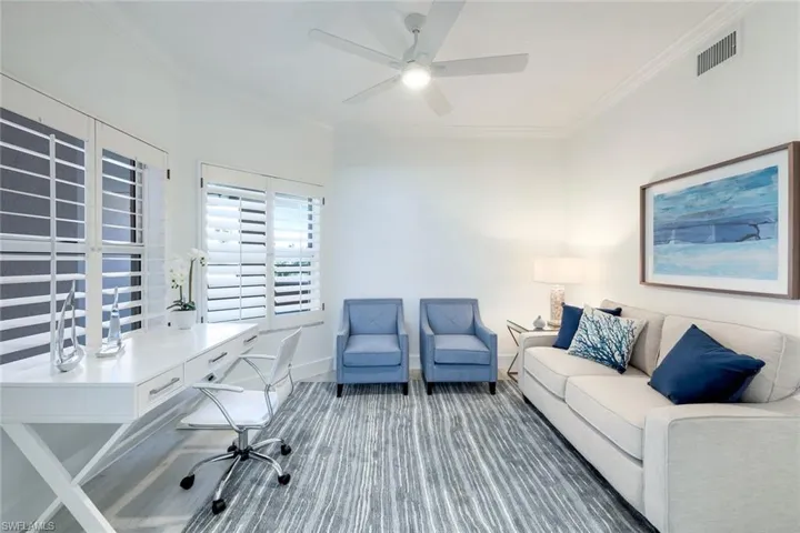 Home office with ornamental molding, a ceiling fan, and baseboards