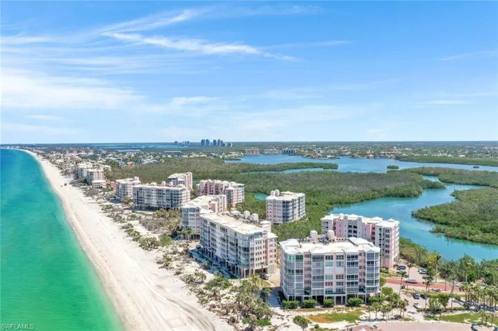 Drone / aerial view of extended coastline and apartment complex