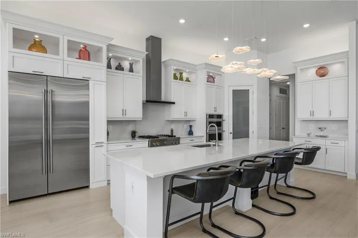 This kitchen is stunning, with custom cabinetry, oversized island, and the one-of-a-kind designer lighting feature above the island. Note the professional grade Jennair appliances--a recent addition to the home at a cost of $34,000.00.