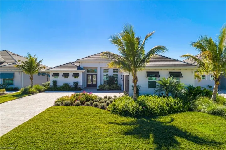 This home features an extra long driveway, oversized lot, professional landscaping, and custom bermuda shutters on the exterior.