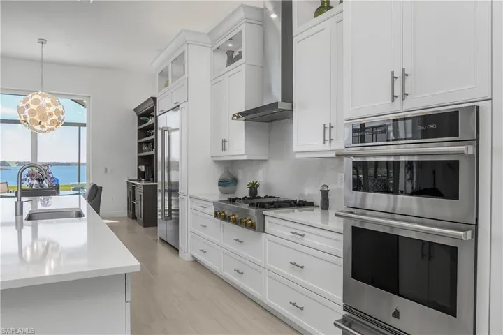 This kitchen is truly a CHEF'S dream with new 48" Jenn-Air RISE side-by-side refrigerator with water dispenser, Jenn-Air RISE 30" microwave, wall oven, 1.5 cubic ft. warming drawer, & RISE Gas Rangetop.