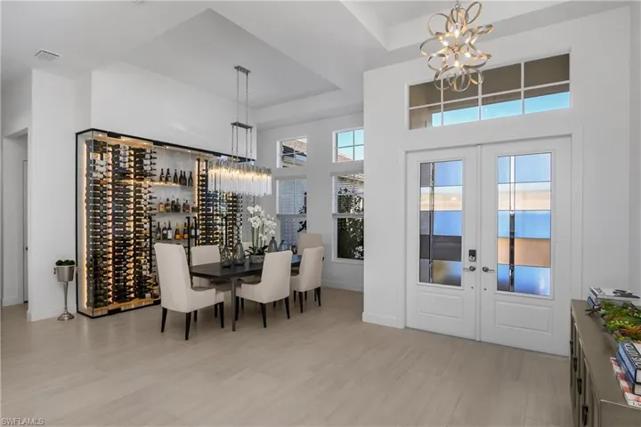 This is a One-of-a-kind home which you'll notice the moment you walk in the door... the foyer has been completely re-imagined, beginning with the elimination of the entry wall to the custom built wine wall, giving the home an open and grande feel!