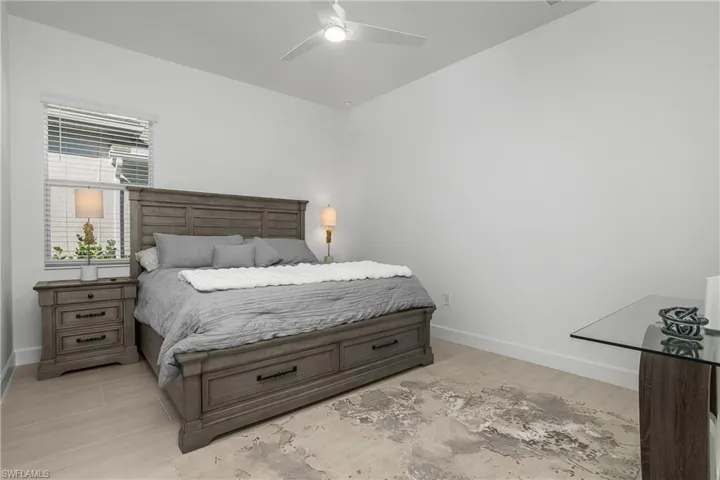 Guest bedroom #1 is located at the back of the home includes its own ensuite bath which leads to the outdoor lanai and pool.