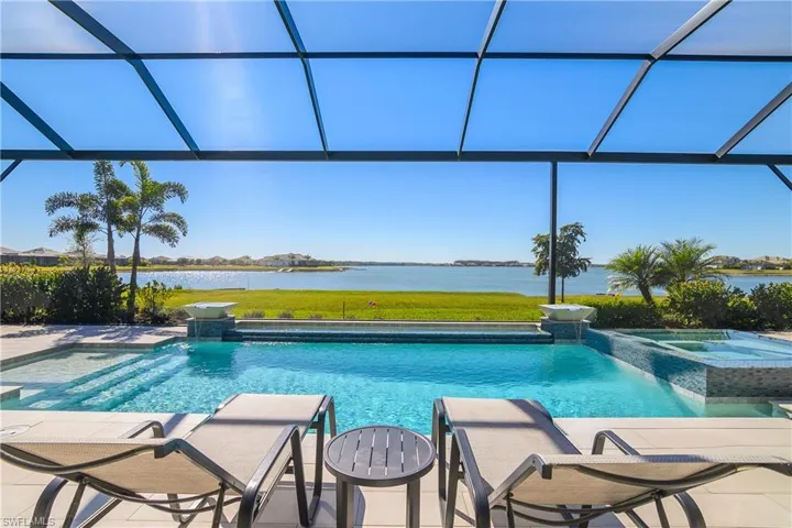 Gorgeous Custom pool and spa has it ALL: glass tile, sun shelf, spillover features, waterfall bowls, automatic water filling system and salt water chlorinator.