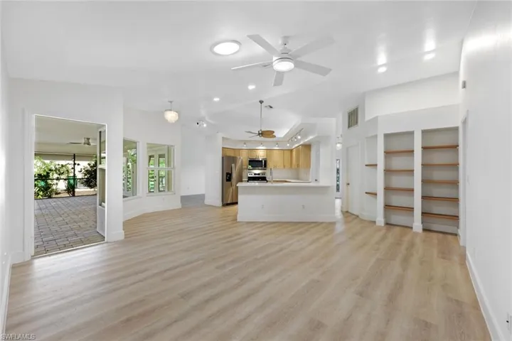 Dining area featuring light wood-style flooring, ceiling fan, lofted ceiling, and built in features
