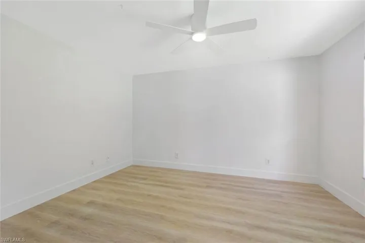 Bedroom #3 with light wood-style flooring and ceiling fan