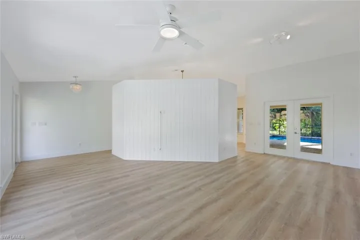 Living room with french doors, light wood-style flooring, and ceiling fan