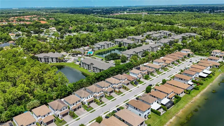 Community featuring residential properties, apartment buildings, and a large body of water