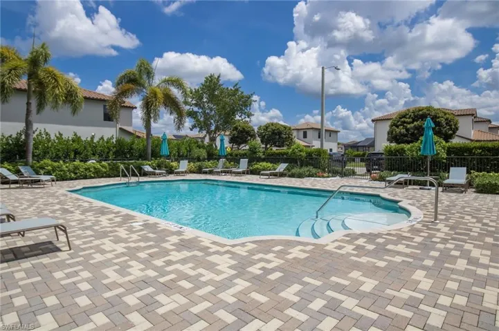 Swimming pool with integrated steps, surrounded by multi-toned paver decking