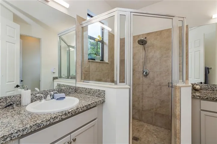 Dual vanity with stone countertops and undermount sinks