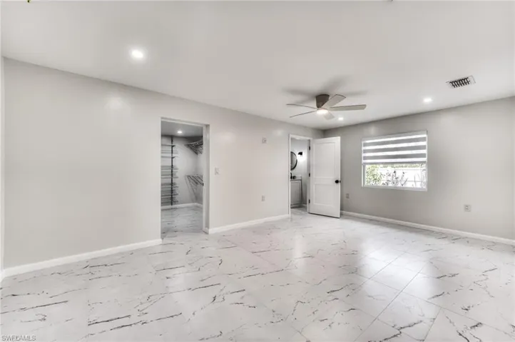 Empty room featuring ceiling fan