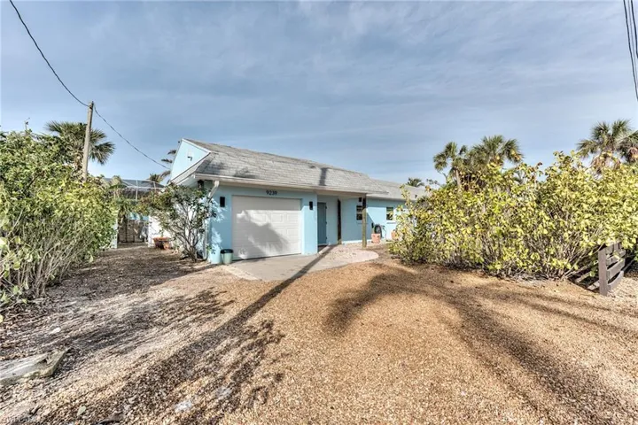 Back of house with a garage