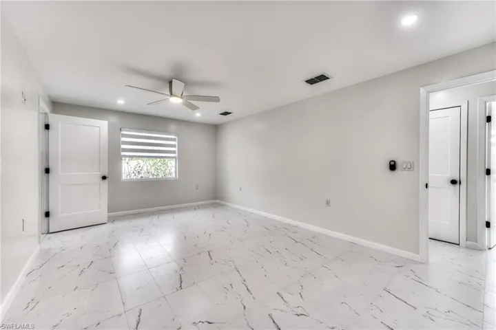 Unfurnished room featuring ceiling fan