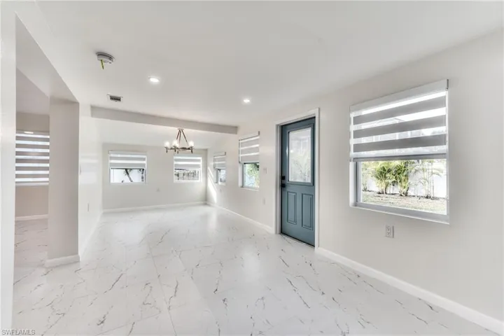 Entryway featuring plenty of natural light and a notable chandelier