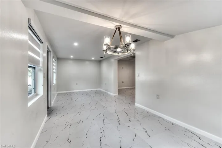 Spare room featuring a notable chandelier