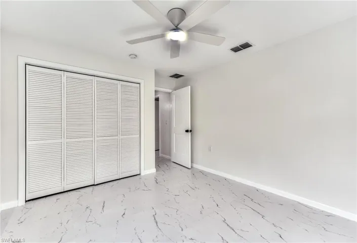 Unfurnished bedroom featuring a closet and ceiling fan