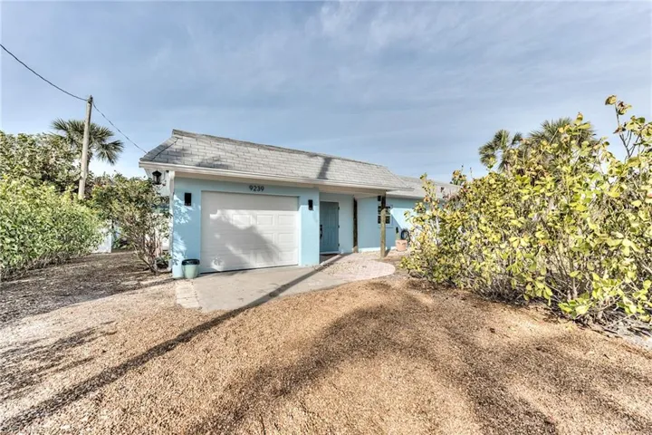 Rear view of property featuring a garage