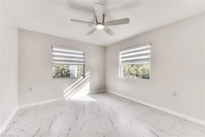 Spare room with ceiling fan