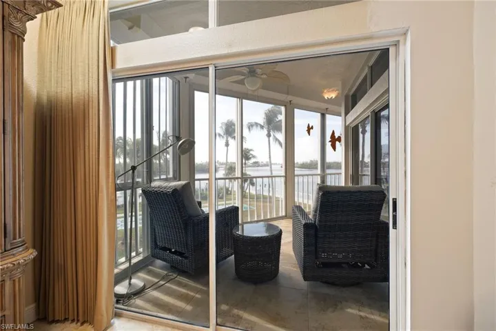 Sunroom / solarium with a water view and healthy amount of natural light