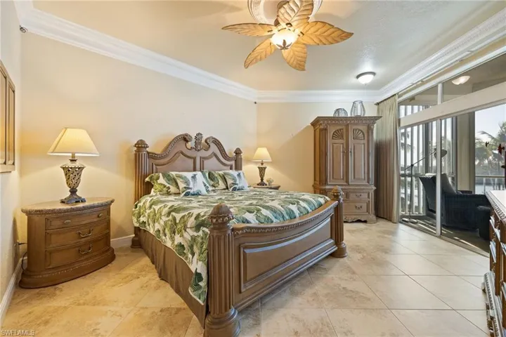 Bedroom featuring crown molding, access to exterior, ceiling fan, and light tile patterned floors