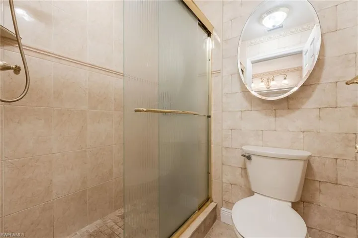 Bathroom featuring a stall shower and toilet