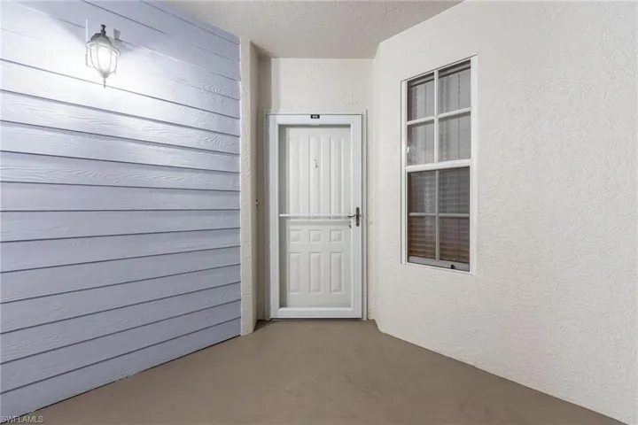 Property entrance featuring stucco siding