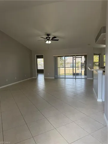 Empty room featuring ceiling fan and light tile patterned floors