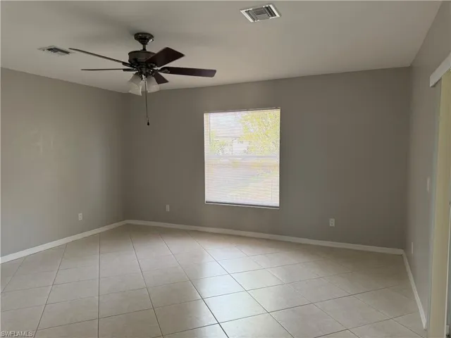 Unfurnished room featuring a ceiling fan and light tile patterned floors