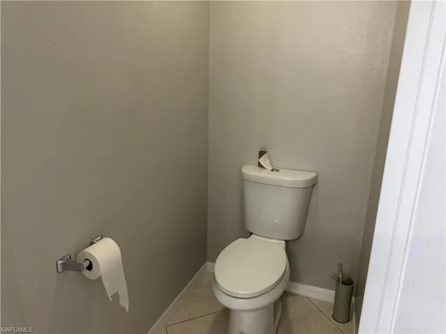 Bathroom featuring toilet and tile patterned flooring