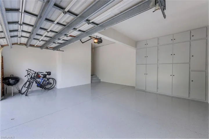 Garage w/New Epoxy Floor covering and freshly painted walls and cabinets