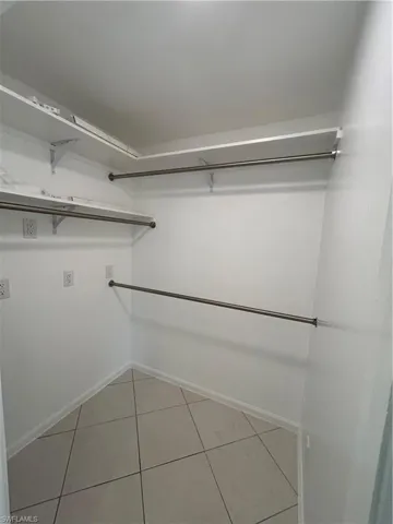 Spacious closet with light tile patterned flooring