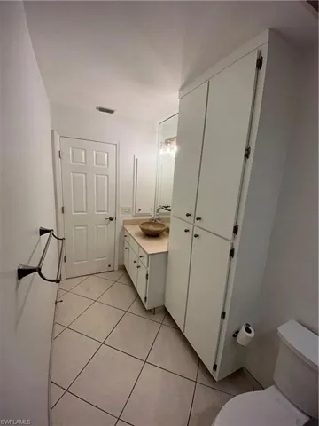 Bathroom with vanity and light tile patterned flooring
