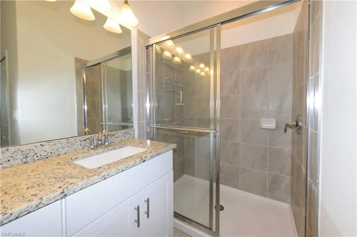 Bathroom with vanity and a shower stall