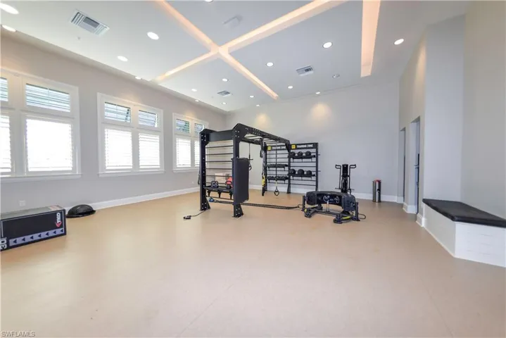 Exercise room with recessed lighting and baseboards