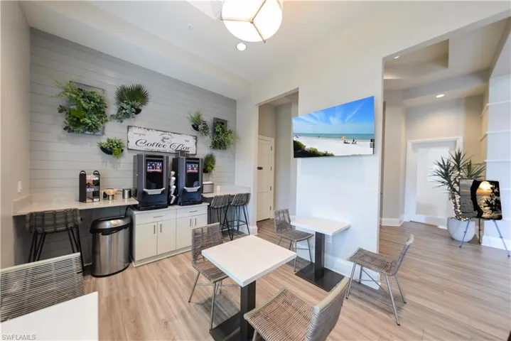 Dining area with light wood-style flooring and recessed lighting