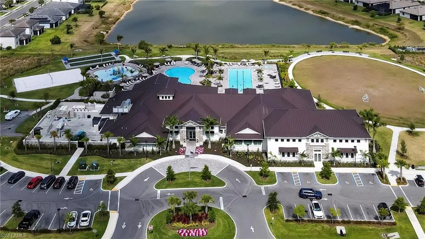 Bird's eye view of a nearby body of water and a pool area