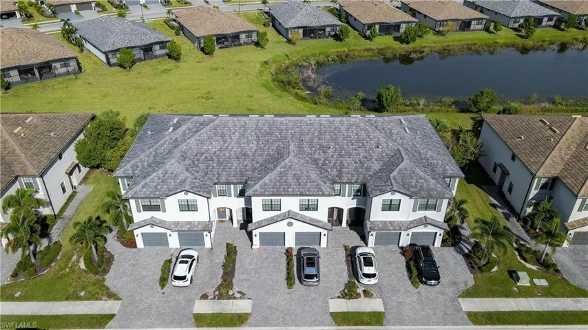 Aerial perspective of suburban area with a nearby body of water