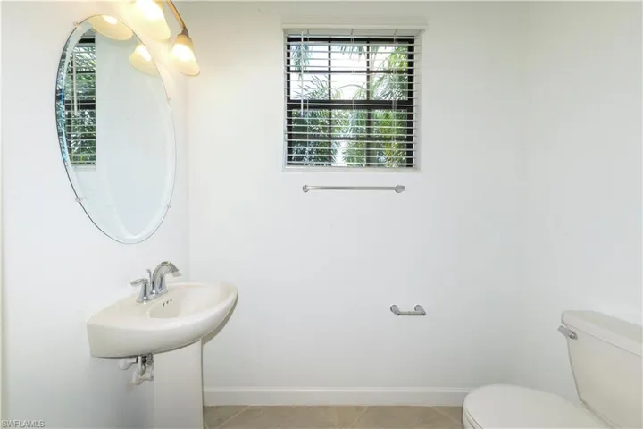 Bathroom featuring baseboards and light tile patterned floors